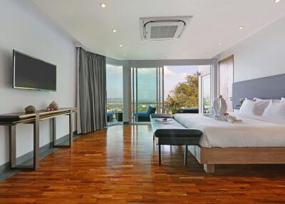 Spacious modern bedroom with large windows and a beautiful view