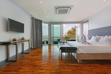 Spacious modern bedroom with large windows and a beautiful view