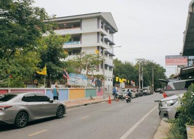 Street view of a multi-story building with adjacent road