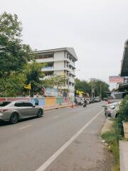 Street view of a multi-story building with adjacent road