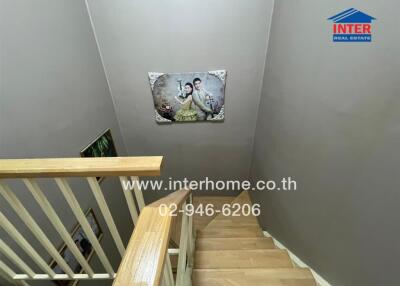 Staircase section with artwork and contact details