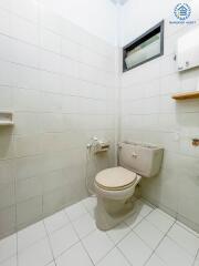 Clean, tiled bathroom with a toilet