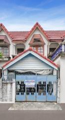 Front view of a residential building with gated entrance