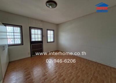 Empty bedroom with tiled floor and windows