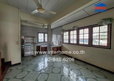 Spacious kitchen with large windows and modern appliances
