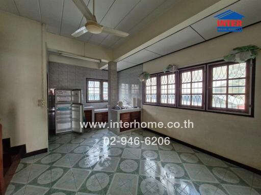 Spacious kitchen with large windows and modern appliances