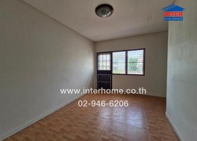 Empty bedroom with tiled flooring and window