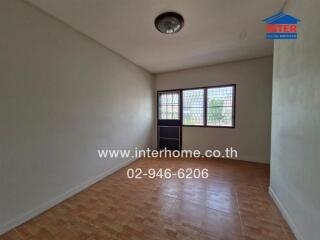 Empty bedroom with tiled flooring and window