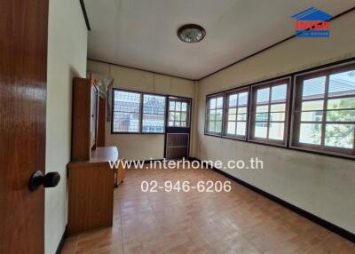 Bedroom with large windows and tiled flooring