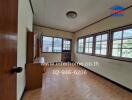 Bedroom with large windows and tiled flooring