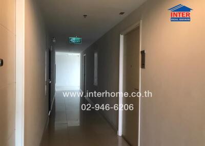 Apartment hallway with exit sign and doors