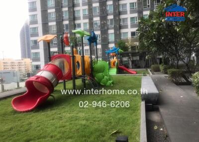 Outdoor playground area at an apartment complex with slides and play structures