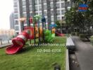 Outdoor playground area at an apartment complex with slides and play structures