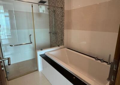 A modern bathroom with a bathtub and a glass-enclosed shower