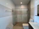 Modern bathroom with glass shower enclosure and sleek fixtures