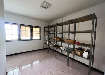 Empty storage room with metal shelving and tiled flooring