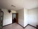 Empty bedroom with a door and ceiling fan