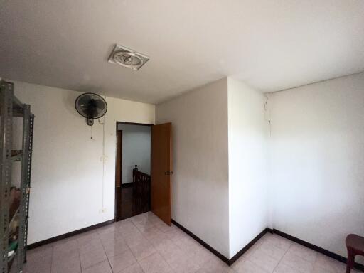 Empty bedroom with a door and ceiling fan