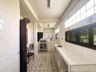 Spacious kitchen with tiled floor and large windows