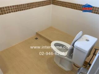 Modern bathroom with tiled floor and toilet