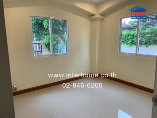 Empty bedroom with windows and shiny tile floor