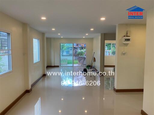 Spacious living area with large windows and access to the garden.