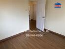 Empty room with wooden flooring and open door