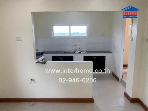 Small kitchen with a sink, countertop, and wall-mounted cabinets