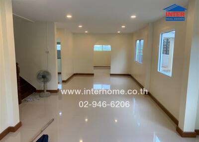 Spacious and bright main living area with glossy tiled floors and ample natural light