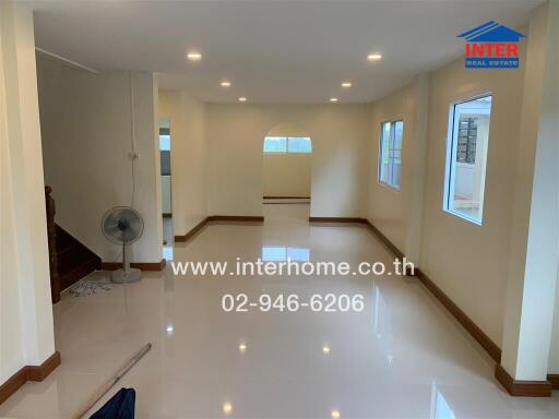 Spacious and bright main living area with glossy tiled floors and ample natural light