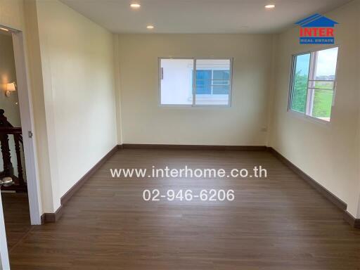 Unfurnished bedroom with wooden floor and windows