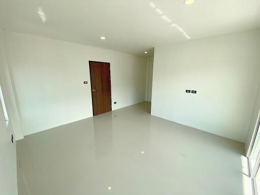 Empty room with a wooden door