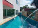 Outdoor pool area with modern building