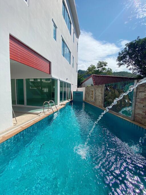 Outdoor pool area with modern building