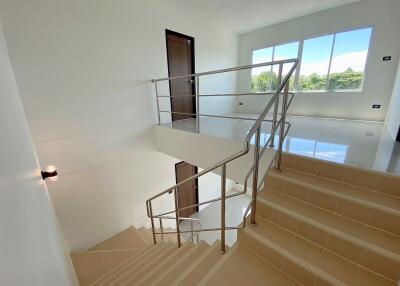 Staircase leading to upper floor with natural light