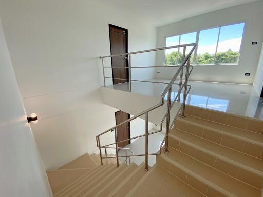 Staircase leading to upper floor with natural light