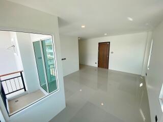 Spacious living room with large window and balcony access