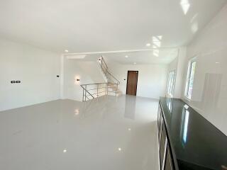 Spacious modern living area with staircase