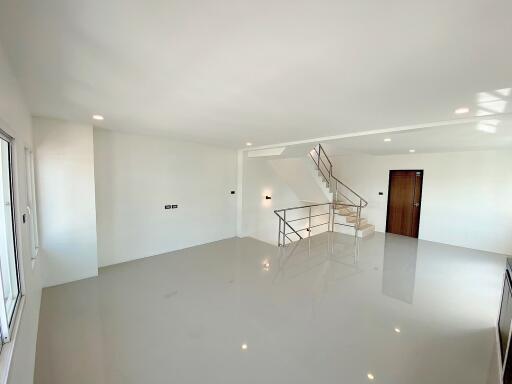 Spacious living room with modern staircase