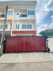 Three-story townhouse with a gated entrance