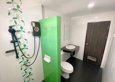 Modern bathroom with green accent tiles