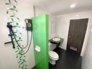 Modern bathroom with green accent tiles