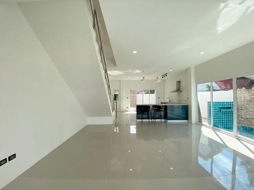 Modern kitchen and dining area with ample natural light