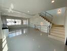 Modern living room with natural light and staircase