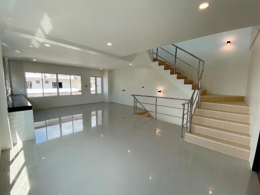 Modern living room with natural light and staircase