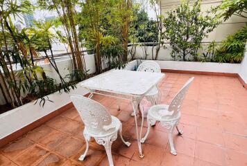 Outdoor patio with white metal furniture