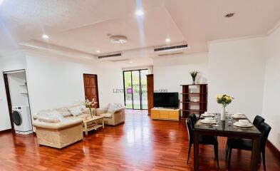 Spacious living room with dining area, wooden flooring, and modern decor