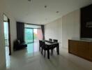 Dining room with table and chairs near sliding glass door to balcony