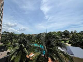 View of the outdoor area with palm trees and partially visible pool