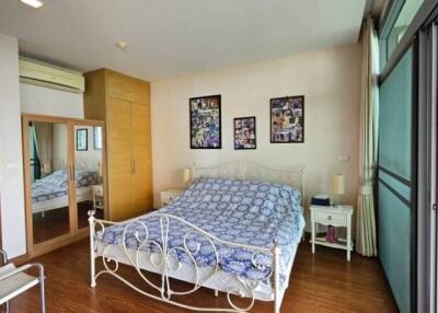 Spacious bedroom with large windows and balcony access